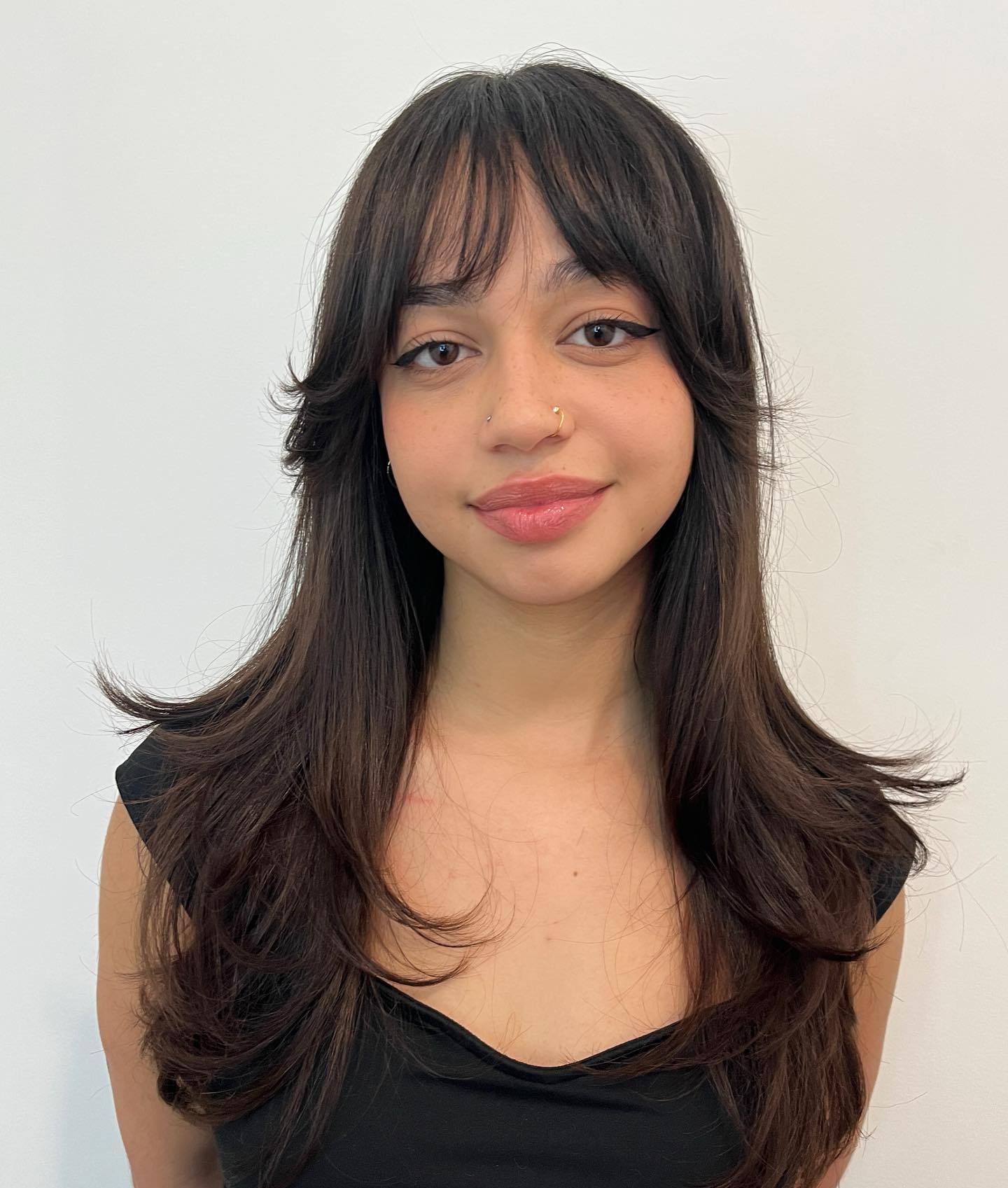 Eyebrow-Skimming Bangs with Long Feathered Sides